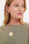 Woman wearing the Gold Jumbo Bonne Chance Coin Necklace, a classic and effortless 14k gold-plated pendant with BONNE CHANCE inscription, exuding fun, high-end style.