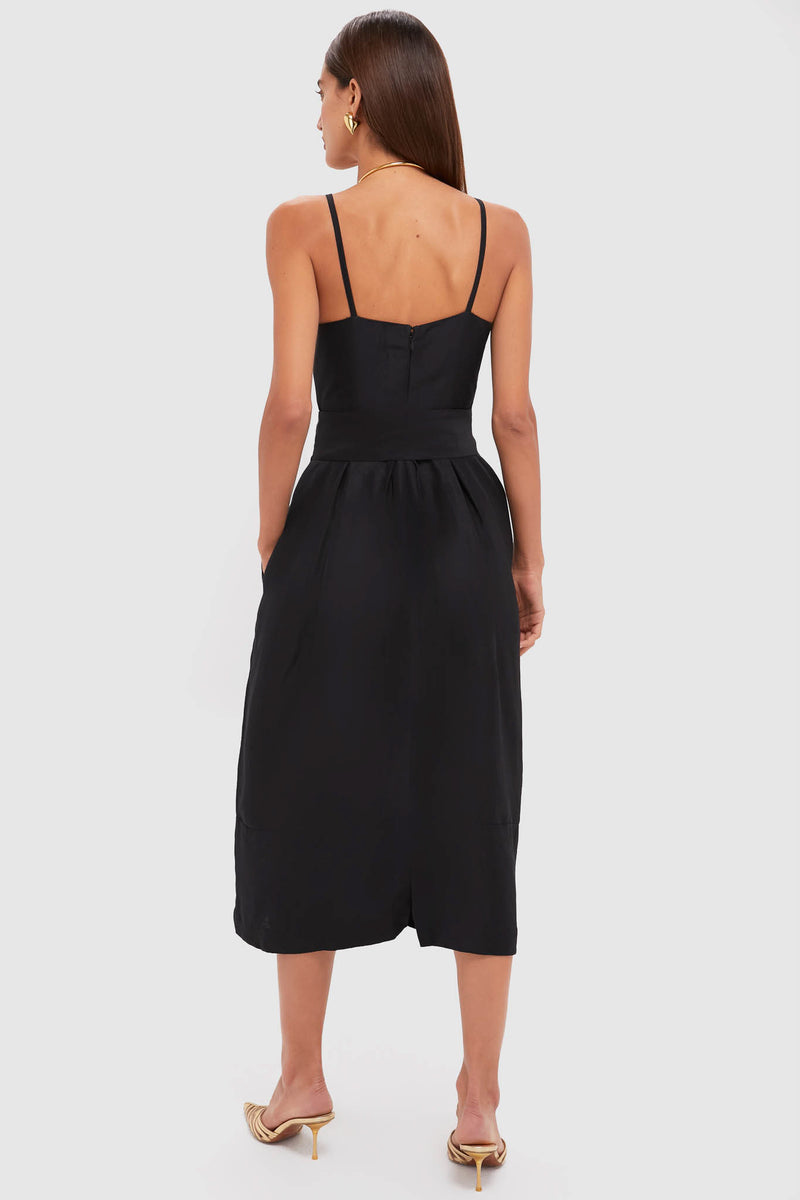 Back view of the Black Artichoke Dress with Belt featuring a fitted bodice, spaghetti straps, and a gathered skirt, paired with gold heels for an effortless, high-end look.