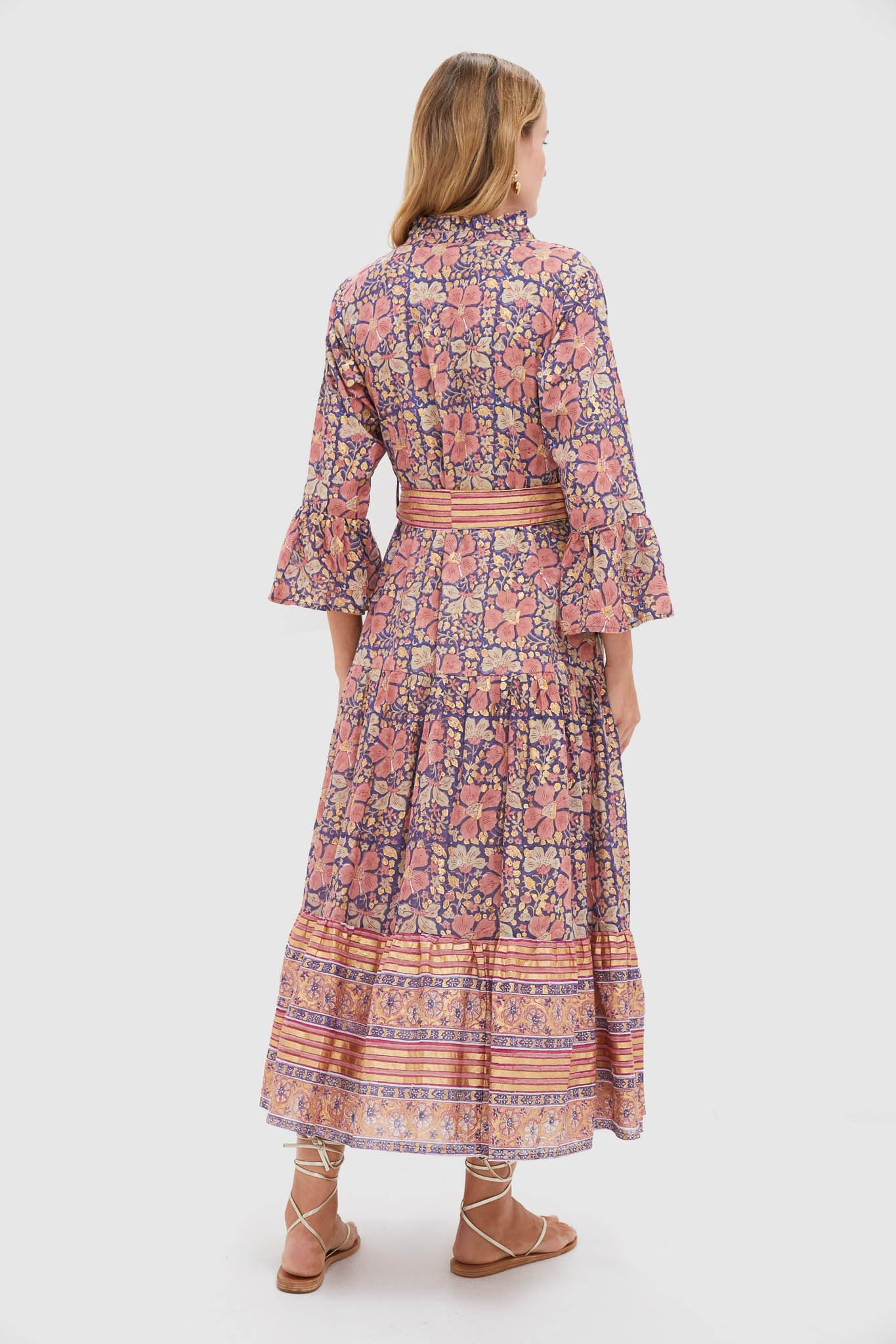 Woman models the Matera Navy Ruffle Collar Bell Maxi Dress, showcasing its classic, effortless bohemian style with a tiered skirt and high-end ruffle collar detail.