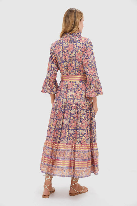 Woman models the Matera Navy Ruffle Collar Bell Maxi Dress, showcasing its classic, effortless bohemian style with a tiered skirt and high-end ruffle collar detail.