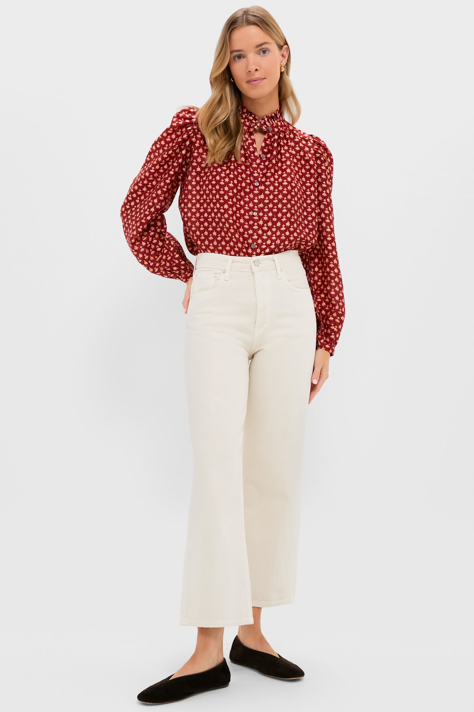 A woman wears an Alix of Bohemia cotton-silk boho-chic blouse with a neck tie, paired with high-waisted off-white wide-leg pants and black flats, standing against a plain white background.