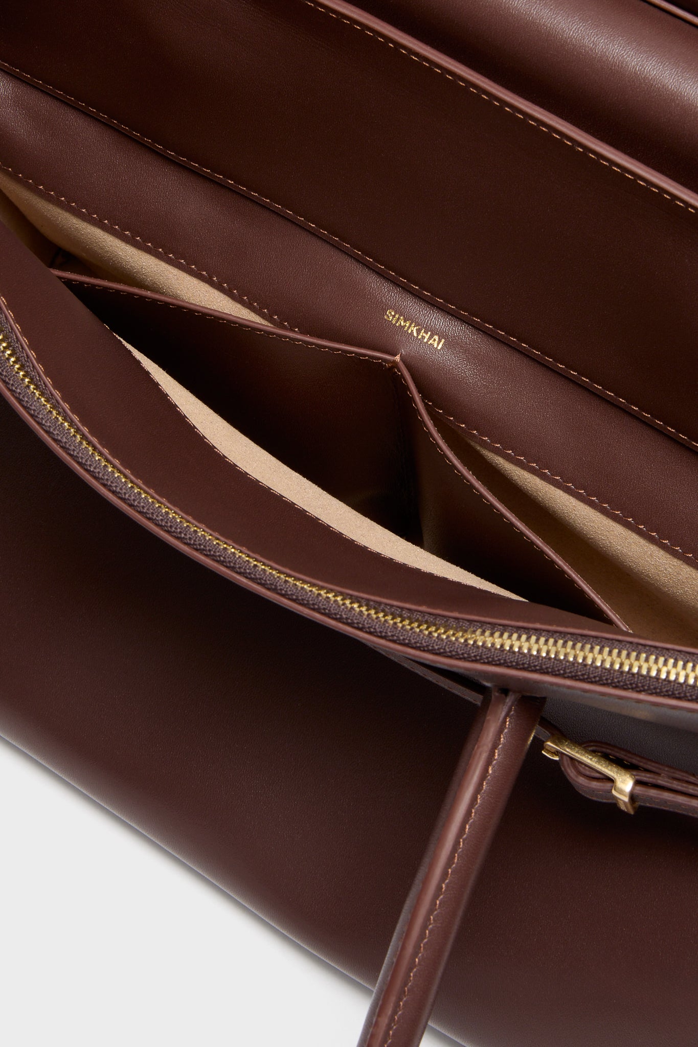 Close-up of the Hickory River Suede Shoulder Bag by SIMKHAI, featuring a classic design with gold hardware, a suede flap, and a chic, effortless silhouette.