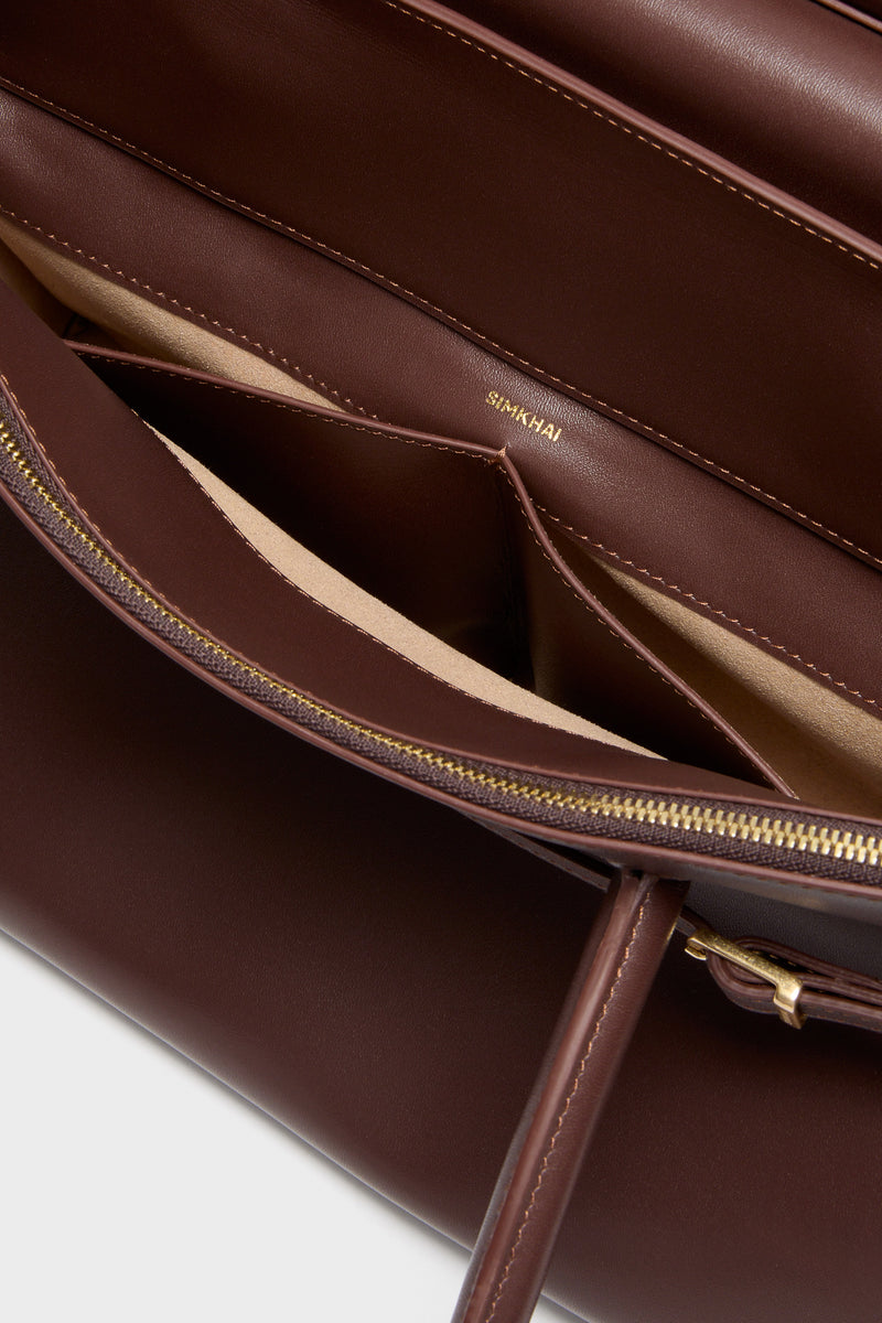 Close-up of the Hickory River Suede Shoulder Bag by SIMKHAI, featuring a classic design with gold hardware, a suede flap, and a chic, effortless silhouette.