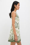 Woman in profile wearing the Ireland Green Layla Mini Dress, featuring a classic sleeveless design with botanical motifs and a high-end, effortless A-line silhouette.