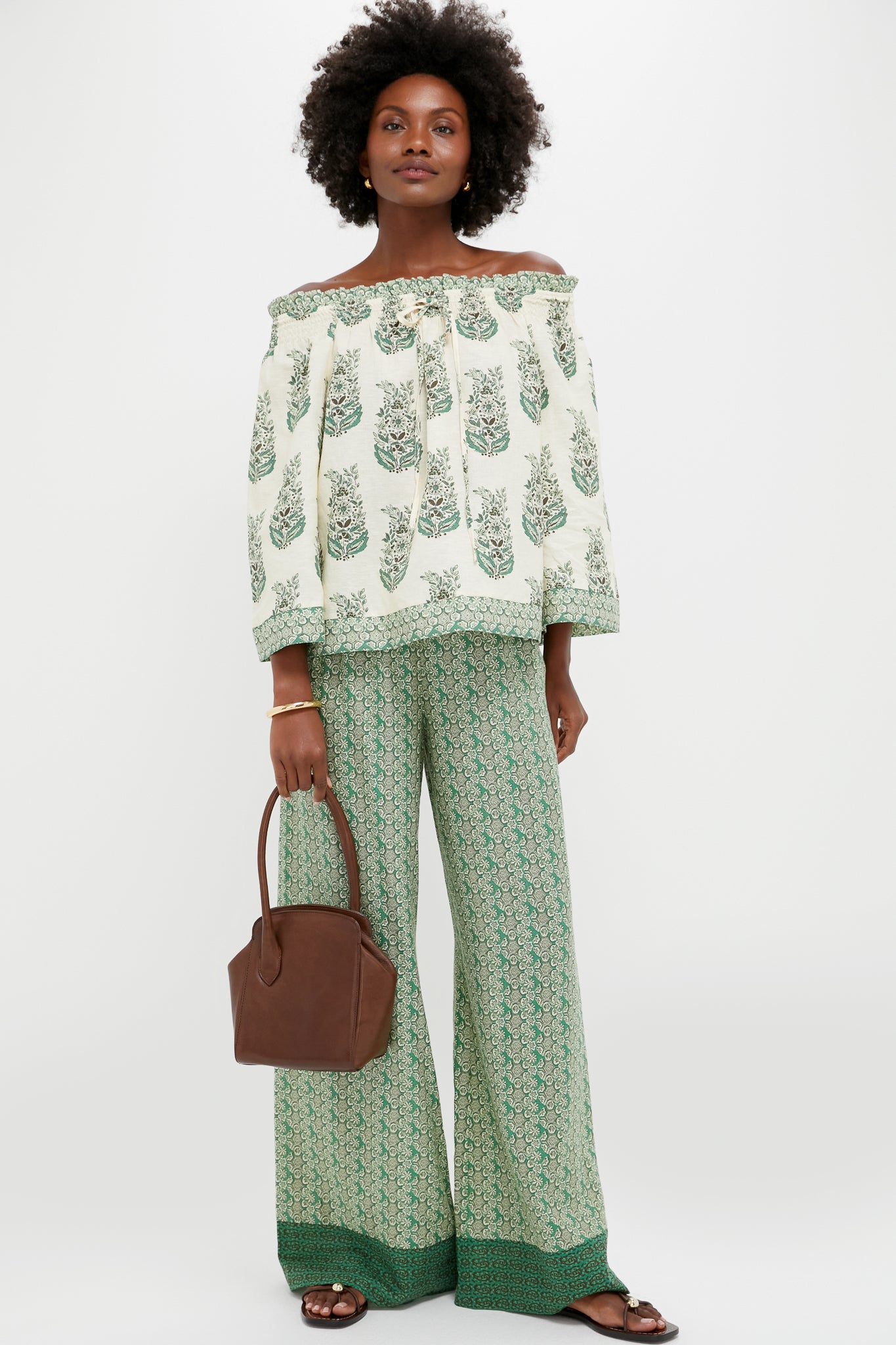 Model holding the classic Dark Brown Leather Sporty Lady Bag, showcasing its effortless, high-end style with a fun, sculptural silhouette and signature one-handle design.