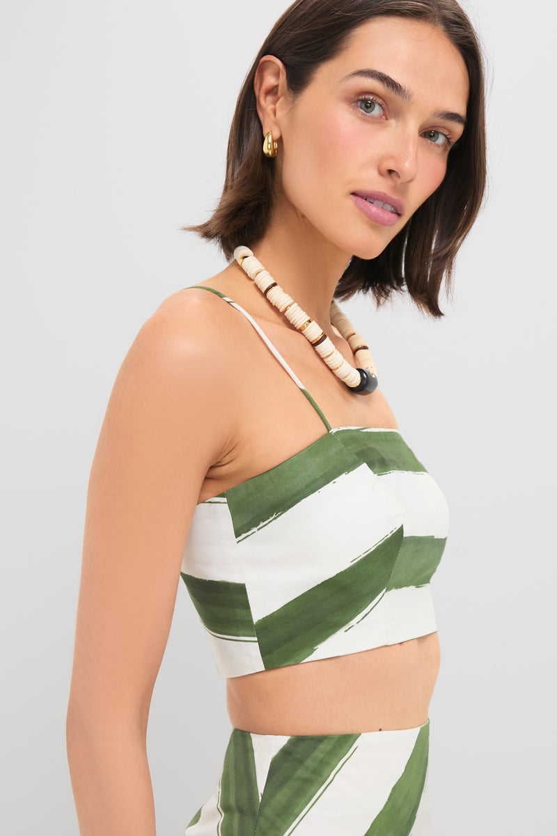 Young woman wearing the classic Green Stripe Nature Top, a cropped, spaghetti-strap bustier with green stripes, exuding an effortless and fun, high-end vibe.