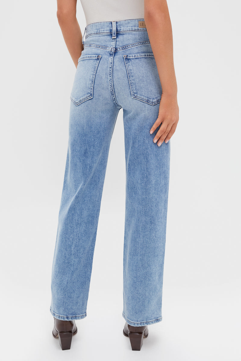 Model in classic, effortless LE JEAN Big Chill 90's Mid Rise Straight Ankle jeans, showcasing high-rise fit and clean hem, paired with high-end dark block-heel ankle boots.