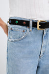 Effortless classic style: the Black Stone Embellished Harness Belt with colorful semi-precious stones and a gold buckle elevates high-rise jeans for a high-end, fun look.