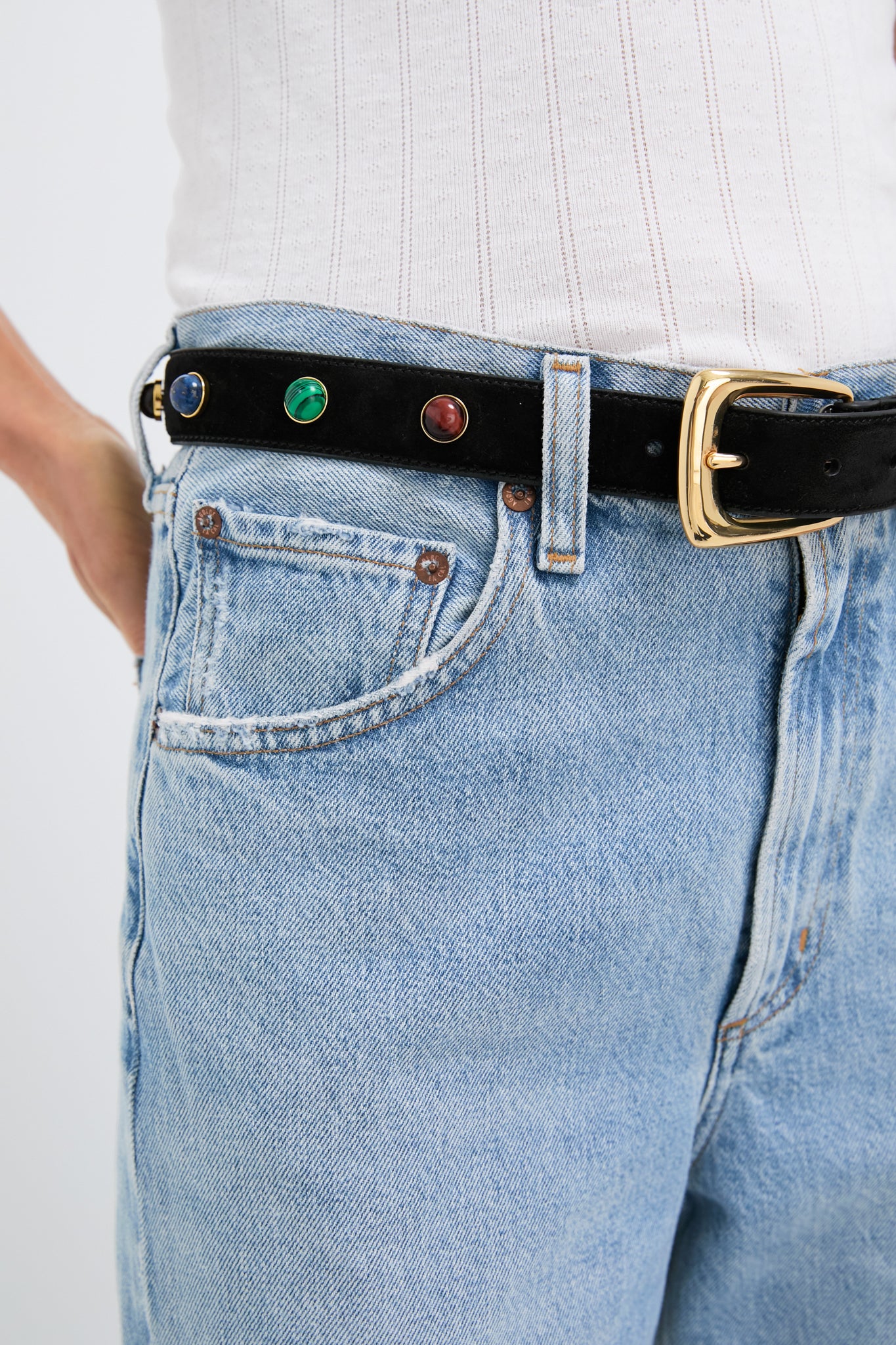 Effortless classic style: the Black Stone Embellished Harness Belt with colorful semi-precious stones and a gold buckle elevates high-rise jeans for a high-end, fun look.