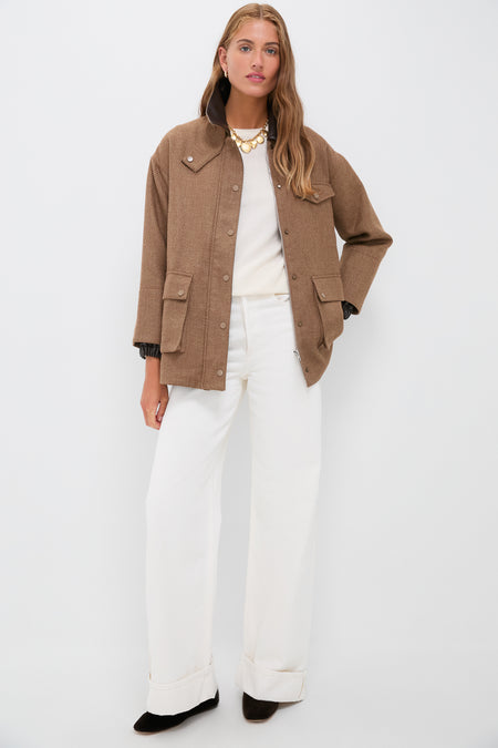 Woman wearing the classic Brown Bourbon Jacket with faux leather collar, styled effortlessly over a cream top and wide-leg trousers, embodying high-end, fun sophistication.