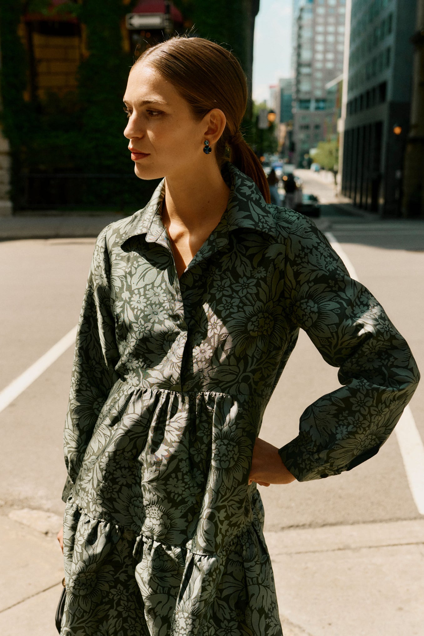 Woman in city wearing Lagoon Myrla Earrings, showcasing classic, effortless style. The high-end, drop silhouette adds fun and elegance to her look.