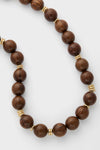Wood and Gold Beaded Necklace: Classic and effortless, this high-end piece combines warm wood beads with fun, shimmering gold accents for versatile elegance.