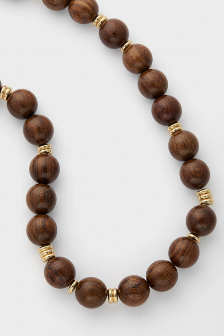 Wood and Gold Beaded Necklace: Classic and effortless, this high-end piece combines warm wood beads with fun, shimmering gold accents for versatile elegance.