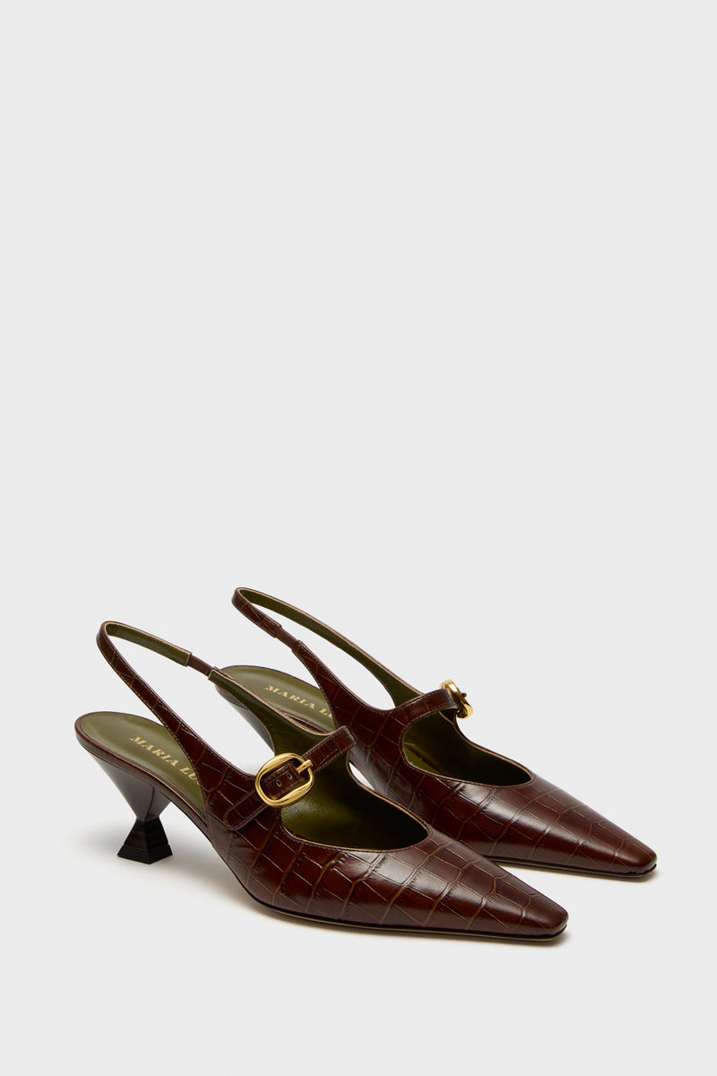 A pair of Maria Luca chocolate crocodile-embossed leather pointed toe slingbacks with gold buckle straps and short block heels, shown on a plain background.