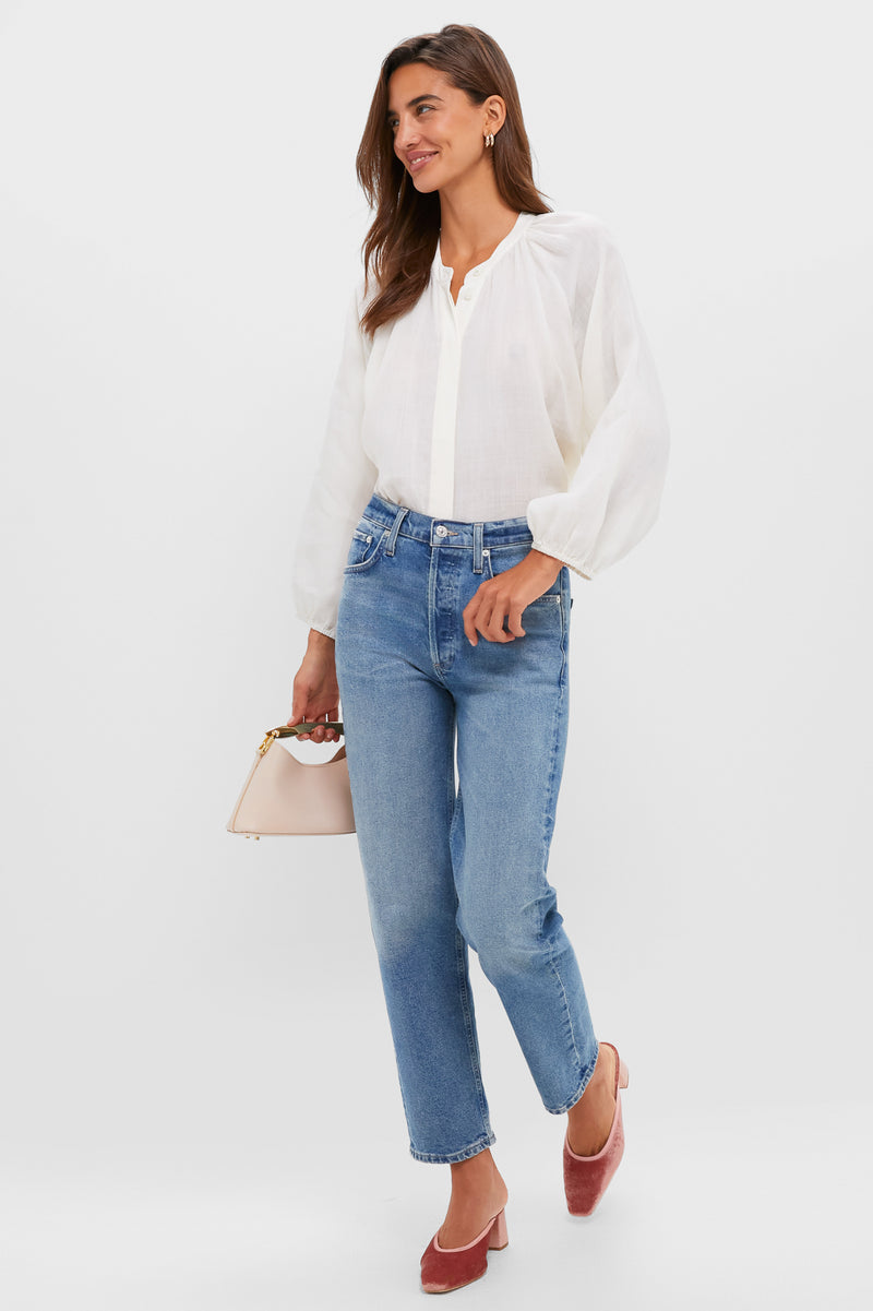 Woman models classic Blush Velvet Tilda Mules with a block heel and square toe, effortlessly styled with jeans, a blouse, and blush handbag, embodying fun, high-end Tuckernuck style.