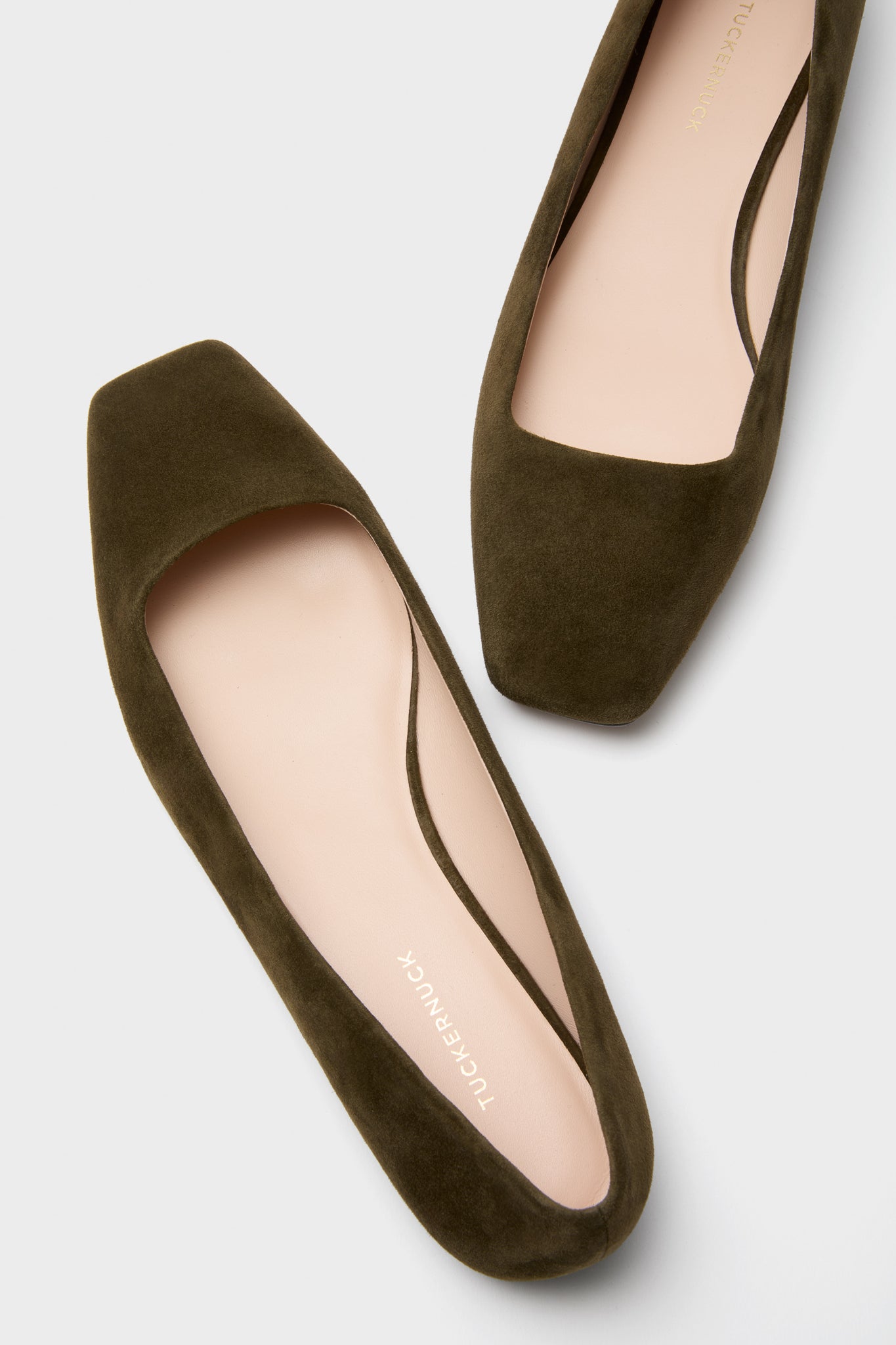 Dark Olive Suede Nadia Flats feature a classic square toe and an effortless slip-on design. These fun, high-end ballet flats include a chic strap and Tuckernuck branding.