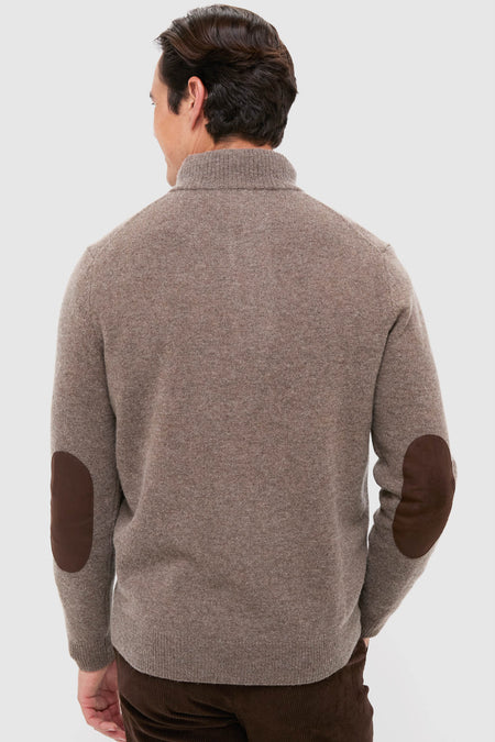 Man in classic Dark Stone Essential Patch Half Zip Knitted Jumper with leather elbow patches, showcasing an effortless style. Perfect for a fun, high-end, cozy look.