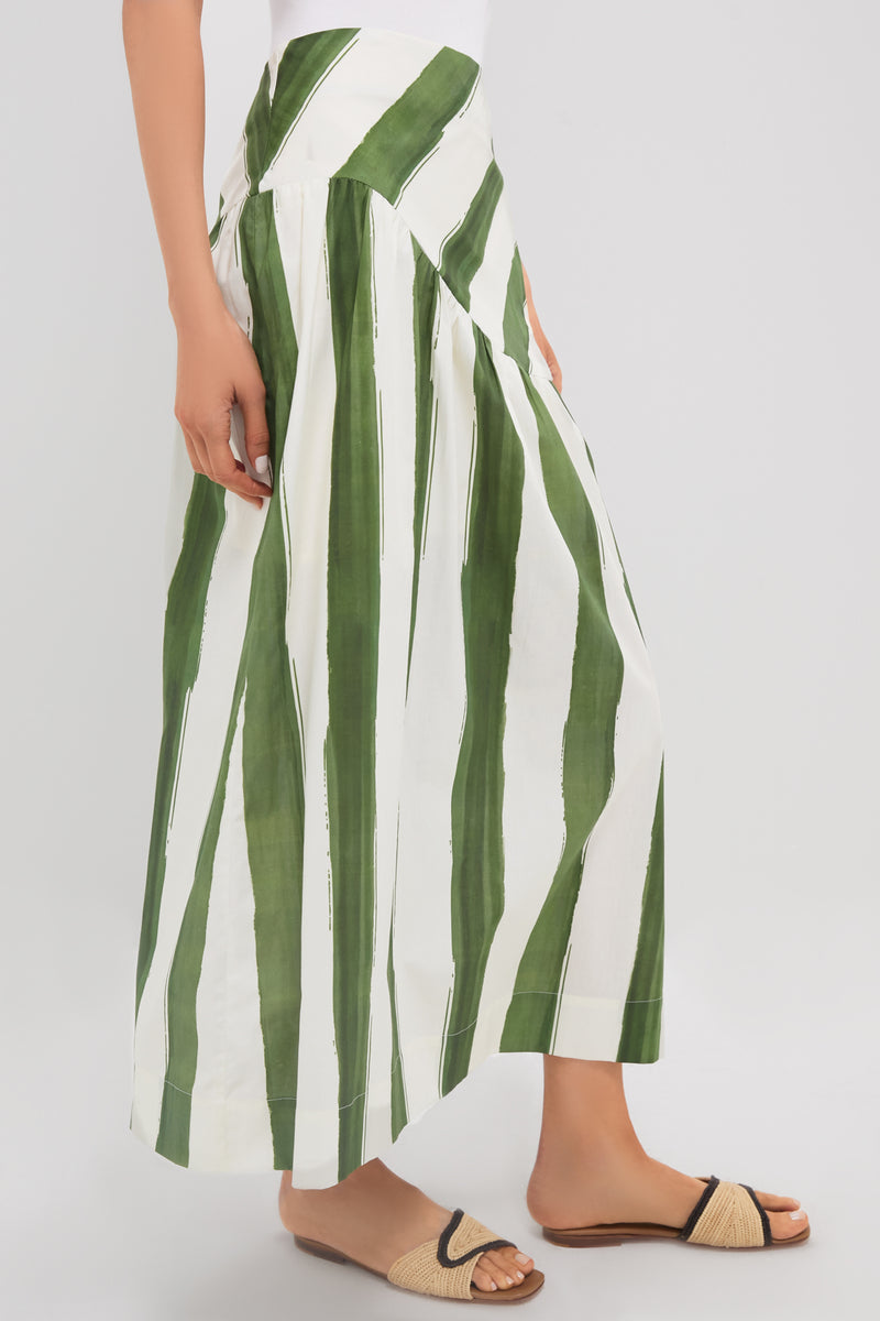 Classic Green Stripe Nature Midi Skirt with drop waist and A-line silhouette, exuding effortless style. Paired with woven sandals for a fun, high-end look.