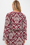 Woman in Blush Pink and Burgundy Bicolor Jacquard Waves Long Sleeve Top, featuring classic baroque patterns and scalloped hem, embodies effortless, high-end style for fun, sophisticated occasions.