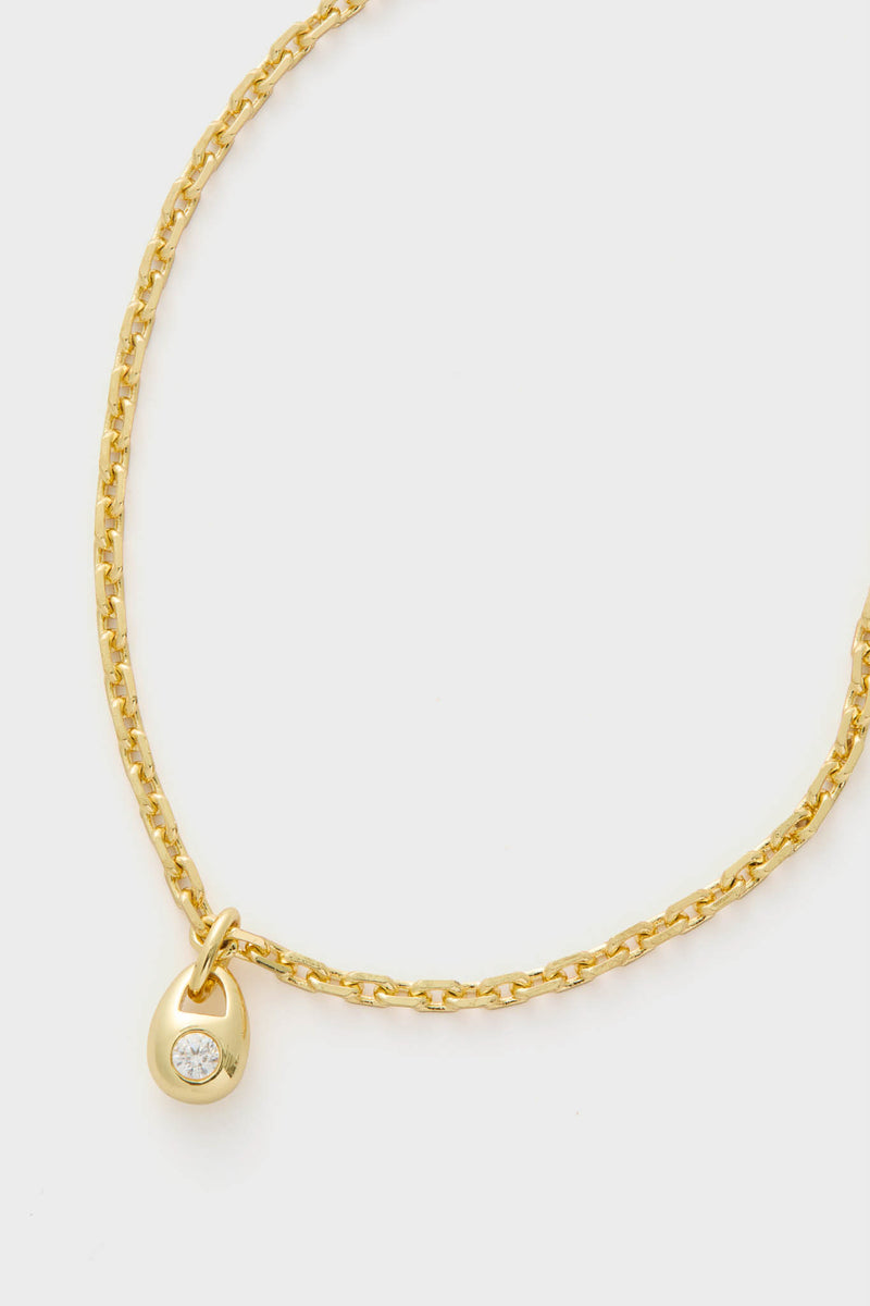 Gold and Crystal Marie Necklace: A classic, high-end gold chain with a teardrop pendant featuring an effortless, fun sparkle from its bezel-set crystal, perfect for any occasion.