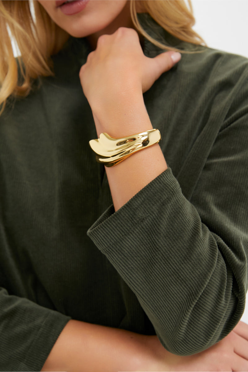 Model wearing the classic High Polish Gold Lydia Cuff, a sculptural, high-end bracelet that adds effortless elegance and fun to any outfit.