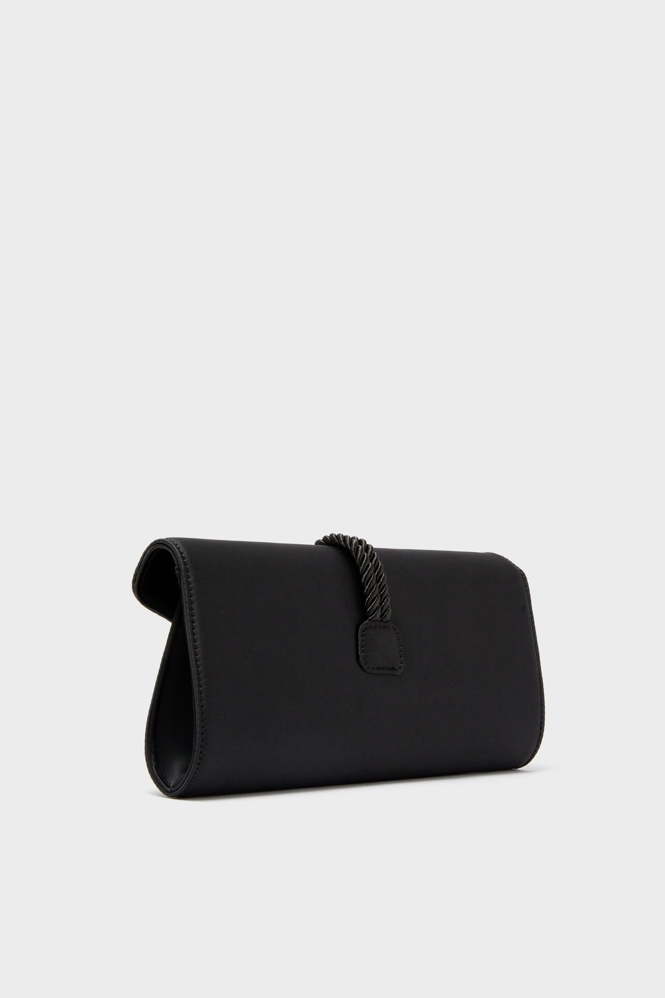 Black Satin Gabrielle Clutch with a classic envelope silhouette, featuring an effortless braided tassel detail and magnetic snap closure, perfect for high-end, fun evenings out.