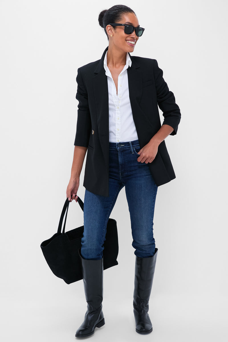 Woman in classic, effortless outfit featuring You're A Riot The Rascal Skimp jeans, styled with a blazer and boots, exuding fun and high-end confidence.