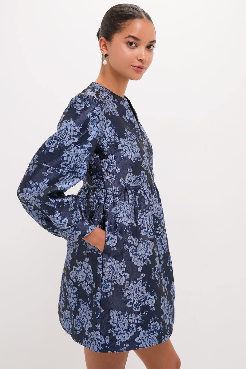 Effortlessly chic, the Blue Jacquard Cressida Mini Dress features a classic floral pattern, high neckline, and voluminous skirt, embodying Tuckernuck's fun, high-end style.