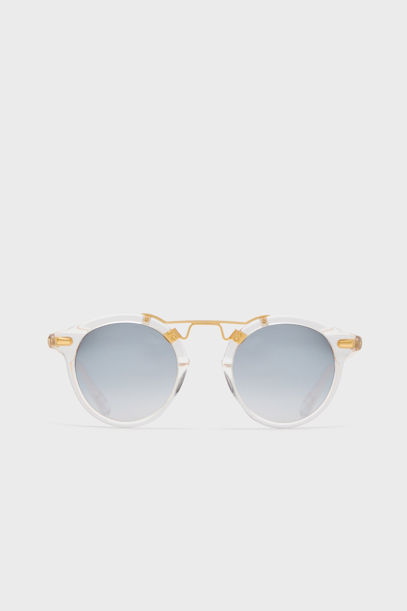 KREWE du optic round clear acetate sunglasses feature a 24k gold-plated bridge and arms, mirrored lenses, and handcrafted frames for a stylish, modern look.
