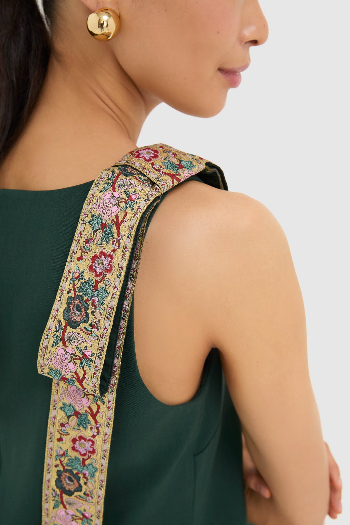 Effortlessly chic, the Garden Scrollwork Jacquard Bow Rosie Dress showcases classic elegance with its floral-embroidered strap and gold-ball earring accent, perfect for high-end occasions.