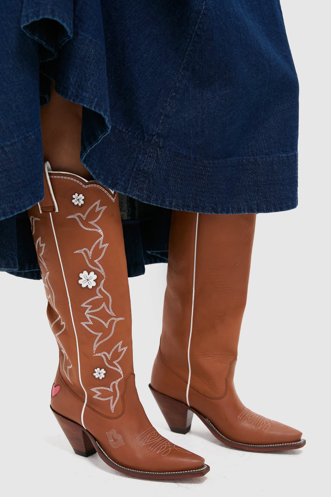 Sierra and White Honey Boots: Classic knee-high Western-style leather boots with scalloped topline, effortless floral stitching, fun heart detail, and elegant hummingbird motifs.