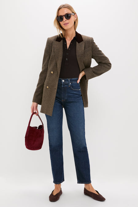 Model in classic Sutherland Blaine Jean, showcasing effortless high-rise fit and straight leg style, paired with chic accessories for a fun, high-end look.