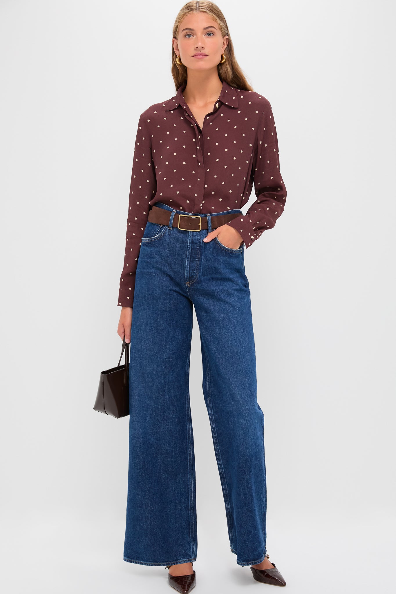 Woman wearing the Night Print Crepe Shirt, a classic, effortless button-down with polka dots, tucked into high-waisted jeans, paired with a structured handbag and heels.