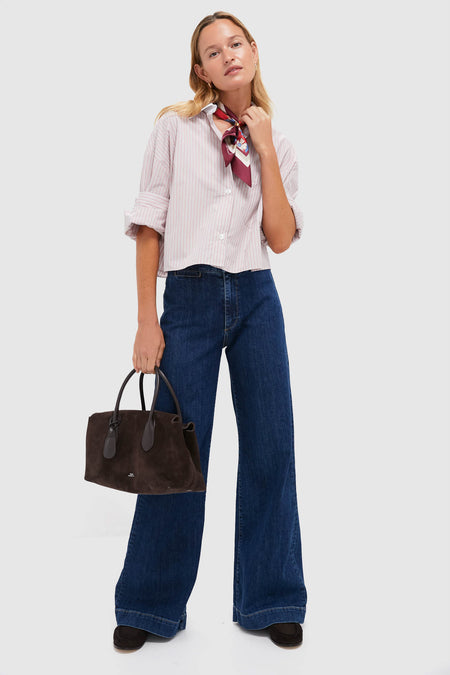 Young woman models the Spanish Villa and White Next Ex Shirt, a classic, cropped button-down with rolled cuffs, paired with high-end wide-leg jeans and a patterned silk scarf.