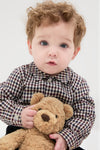 Toddler in classic Burgundy Check Arlo Baby Boy Set, effortlessly holding a teddy bear, showcasing high-end Spanish craftsmanship with a check-patterned shirt and corduroy shorts.