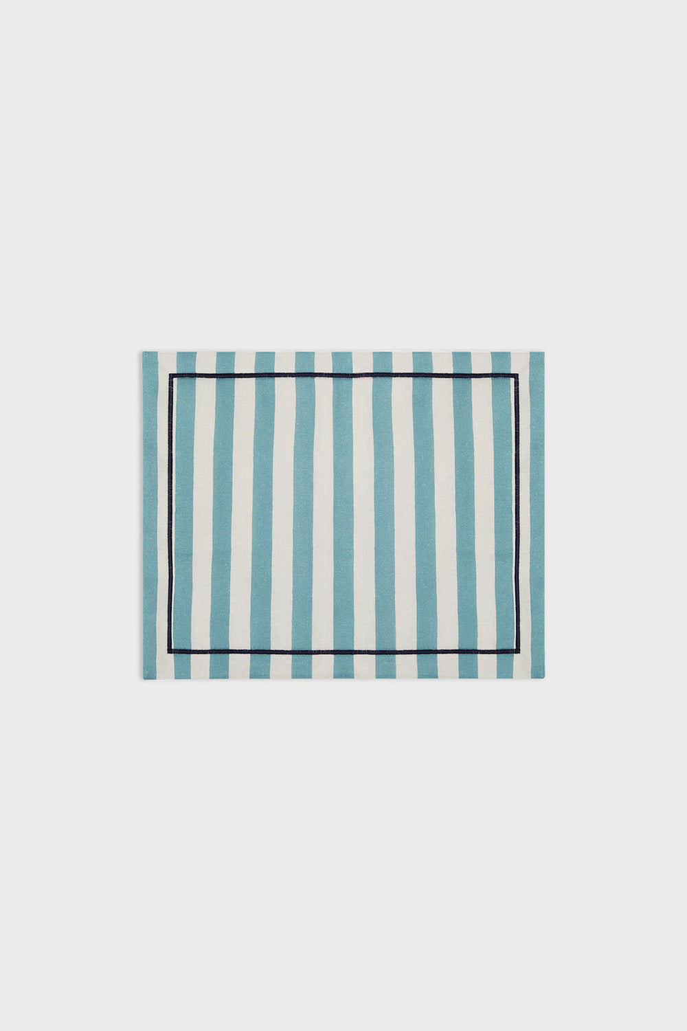 La DoubleJ rectangular linen placemat featuring blue and white vertical stripes with a slim dark border, inspired by classic Italian textile design.