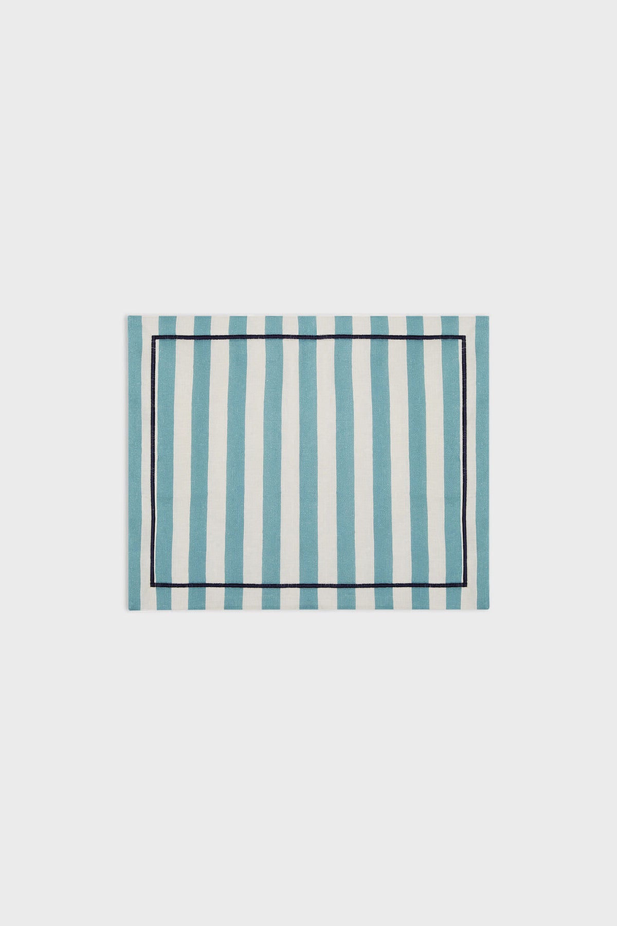 La DoubleJ rectangular linen placemat featuring blue and white vertical stripes with a slim dark border, inspired by classic Italian textile design.