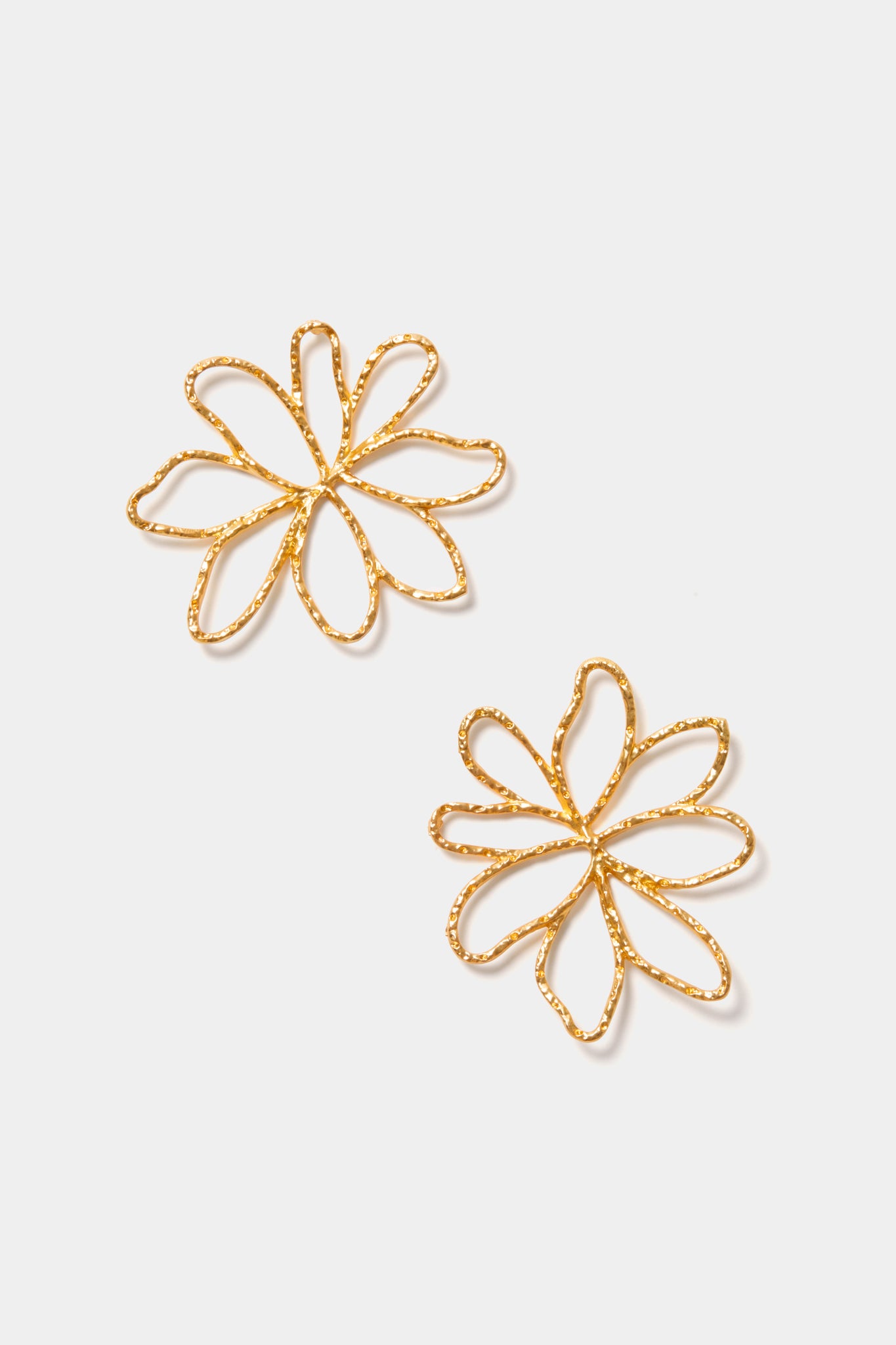 A pair of oversized flower earrings with a radiant gold-plated finish, inspired by the Gold Pomarinho Earrings by Petit Moments.
