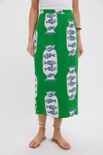 Wearing a Hunter Bell Herring Green linen-blend Isla Skirt with a blue and white vase pattern, paired with a white top and flat strappy sandals.
