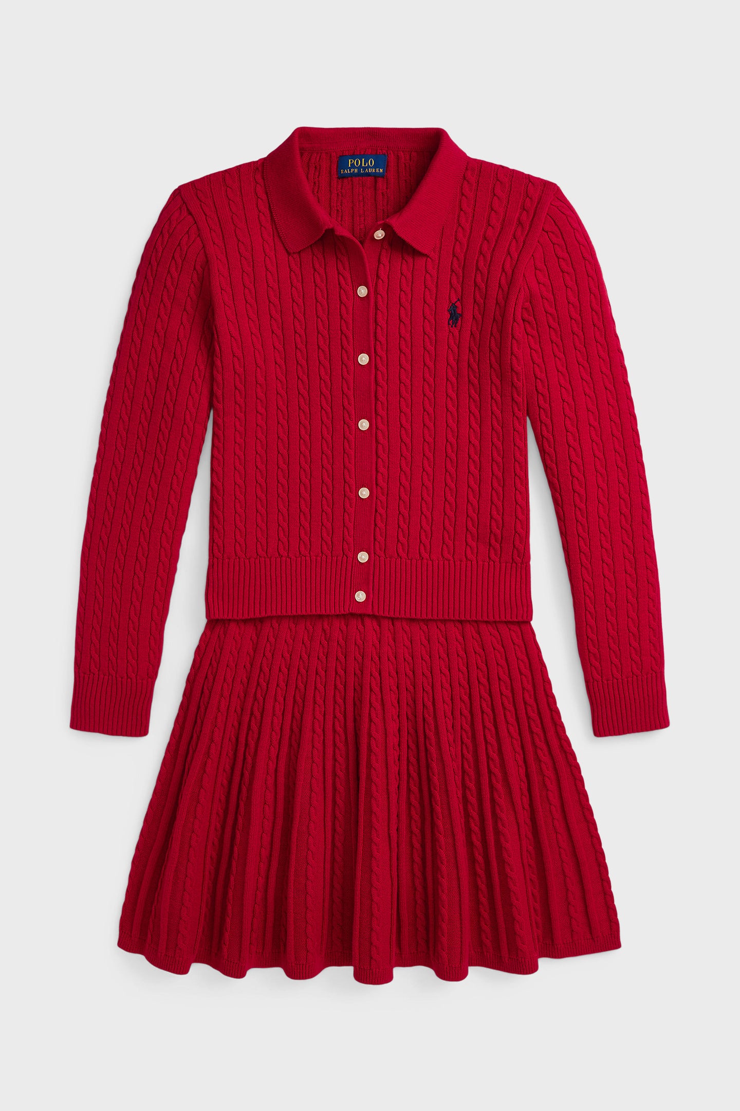A Polo Ralph Lauren red cotton knit dress features long sleeves, a collared button-down front, pleated skirt, and a small embroidered chest logo—perfect for showcasing classic American style.