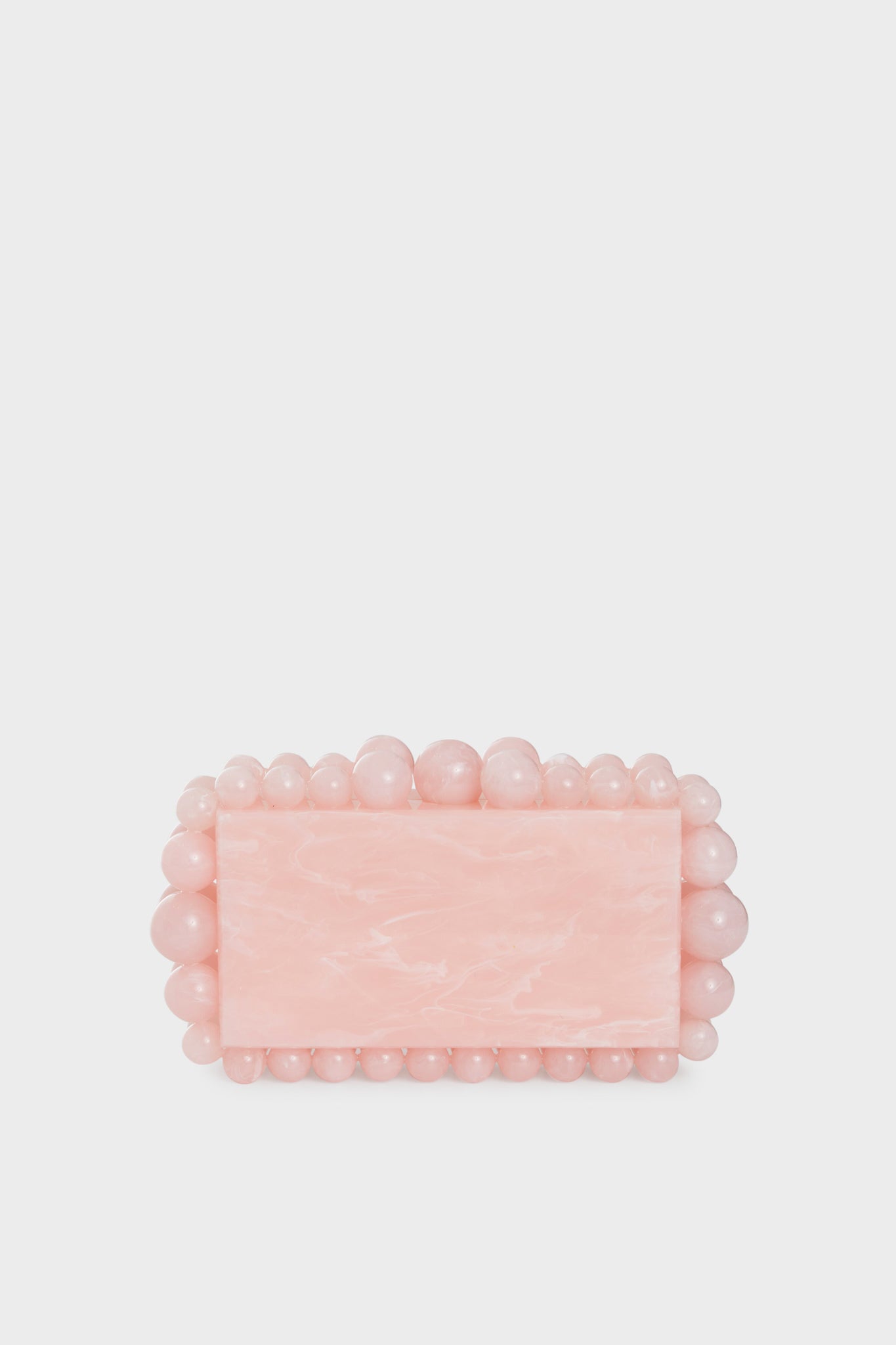 The Cult Gaia rectangular pink acrylic clutch features a marble-like finish with rounded pink beads outlining its edges, making it a chic beaded box clutch for stylish occasions.