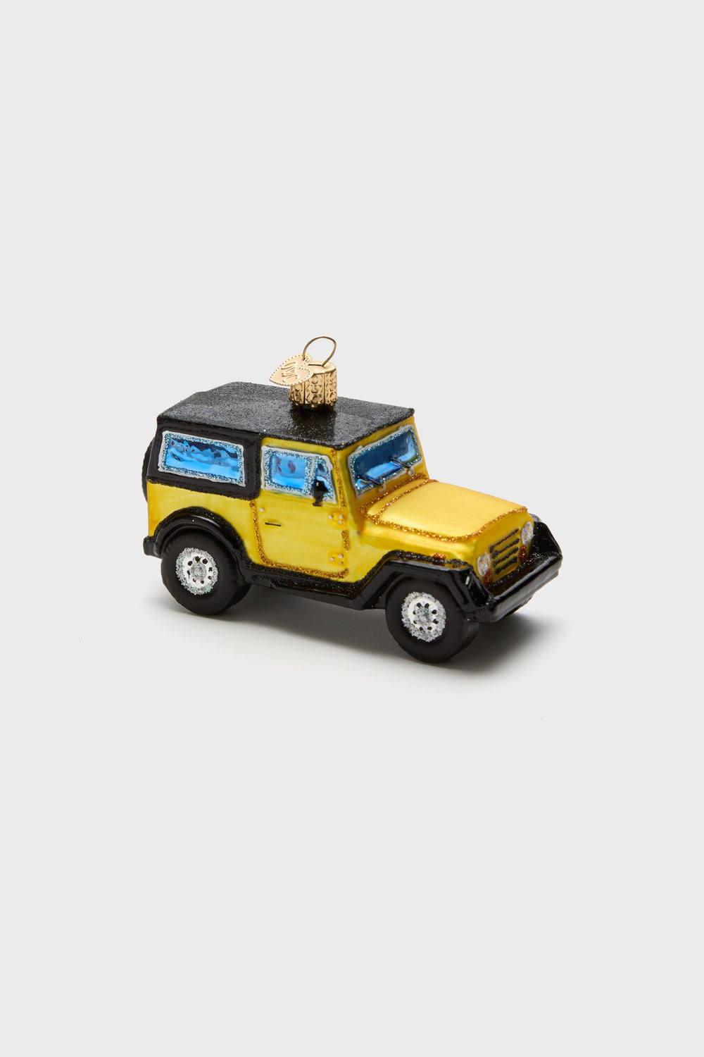 Old World Christmas hand-painted, glass-blown ornament shaped like a yellow and black SUV, with blue windows and a gold hanging loop on top.