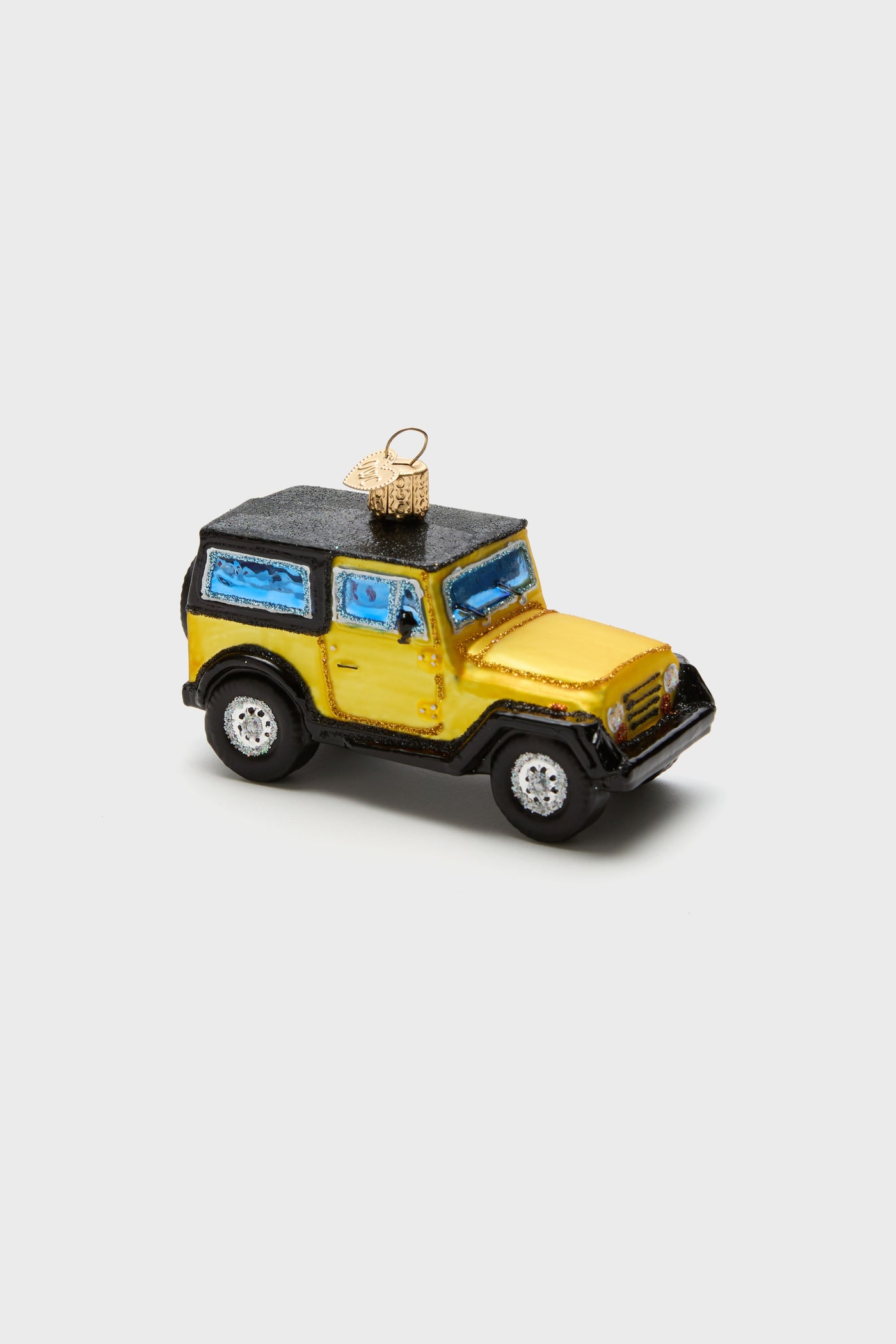 Old World Christmas hand-painted, glass-blown ornament shaped like a yellow and black SUV, with blue windows and a gold hanging loop on top.