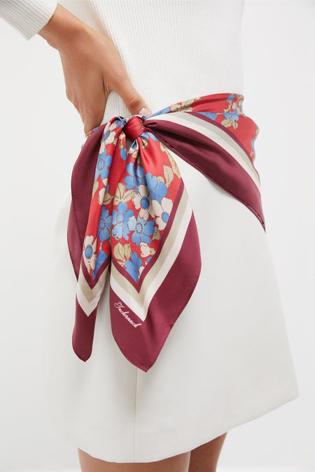 Scarlet Sakura Medium Silk Scarf tied as a belt around waist, showcasing classic, effortless style with high-end floral and stripe design in a fun, chic fashion.