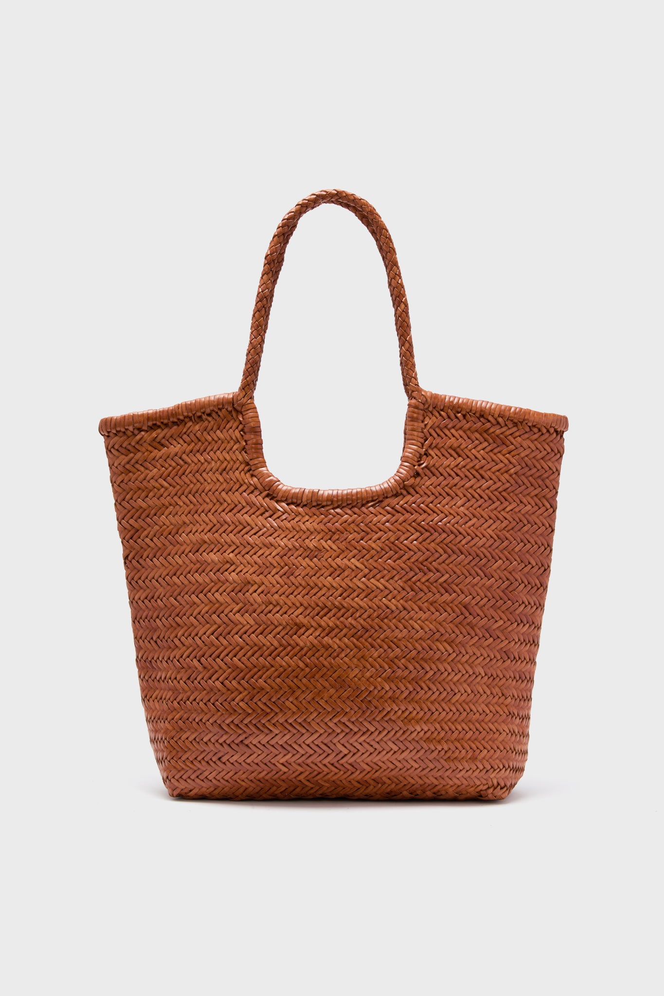 The Dragon Diffusion brown handwoven straw tote bag features braided handles and is perfect for carrying your essentials.