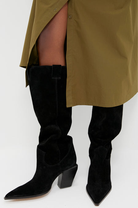 Black Suede Maine Up Boots with pointed toes and chunky heels, paired with an olive-green shirtdress, showcasing classic, effortless style for a fun, high-end look.