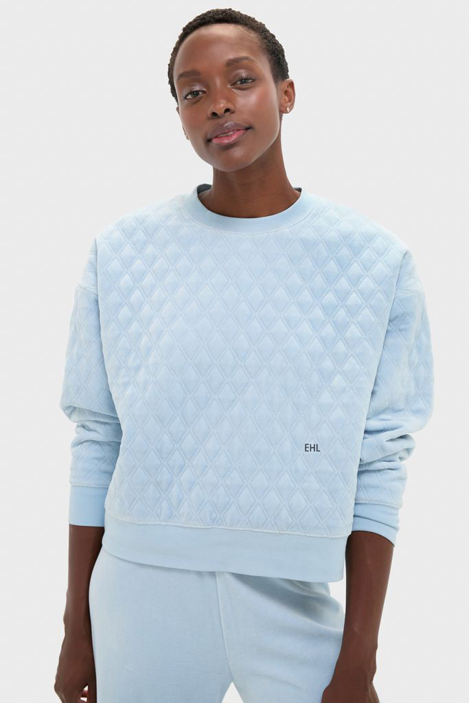 Person wearing a classic, effortless Blue Fog Velour Bennett Pullover with diamond quilting, embodying high-end loungewear style, perfect for relaxed, fun outings.