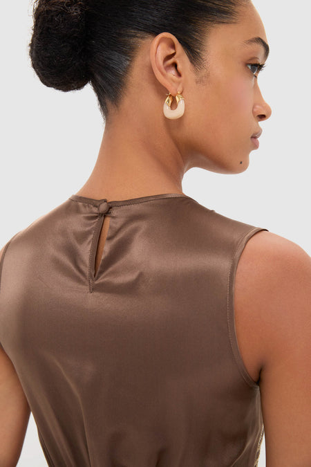 Woman wearing Regio Brown Silk Gioia Midi Dress with an elegant smocked bodice and flowy skirt, showcasing classic, high-end style with effortless, fun sophistication.