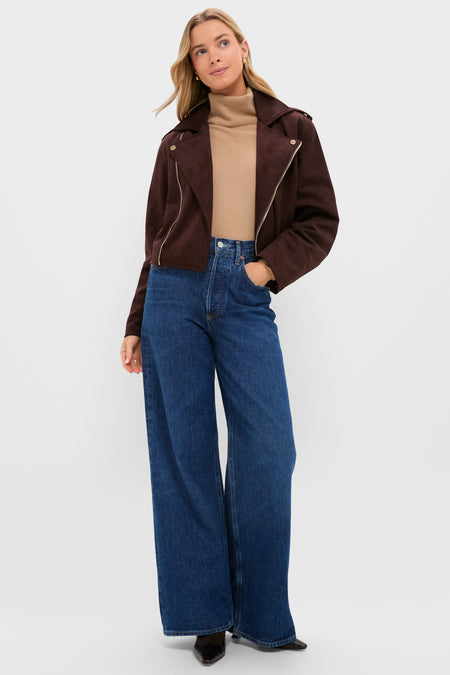 Woman modeling the Chocolate Faux Suede Bristol Jacket, featuring an asymmetrical zip and notch collar, paired with a camel turtleneck and wide-leg jeans for an effortless, classic look.