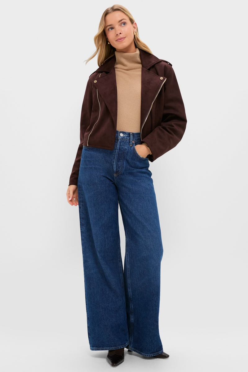 Woman modeling the Chocolate Faux Suede Bristol Jacket, featuring an asymmetrical zip and notch collar, paired with a camel turtleneck and wide-leg jeans for an effortless, classic look.